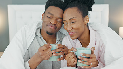 Image showing Coffee, bed and couple with a man and woman in the bedroom to relax in their home together. Drink, tea and romance with a young male and female sitting in their house in the morning over a weekend