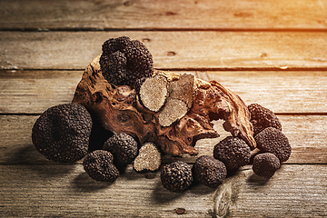 Image showing Whole and slices black truffle mushrooms