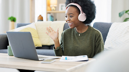 Image showing Woman talking on videocall using laptop and headphones while waving hello to friends online. Student making notes while communicating and learning new language during online course or private lesson