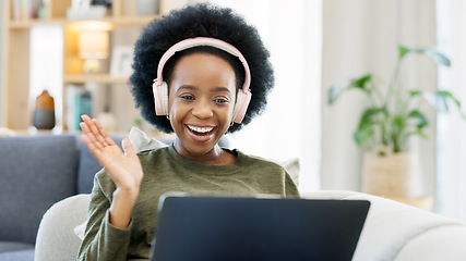 Image showing African woman using laptop and headphones while waving hello during a video call with friends. Student talking to her teacher and learning new language online during online course or private lesson