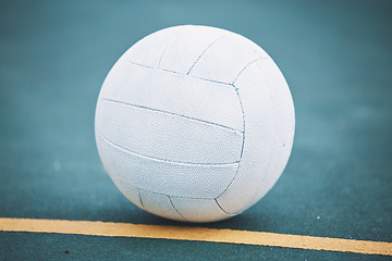 Image showing Netball on the floor on a sport court for a game, training or exercise outdoor on a field. Sports, fitness and white ball on the ground for a match, workout or practice competition by a outside arena