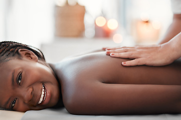 Image showing Black woman, smile and back massage at spa in relax for physical therapy, zen or stress relief at resort. Happy African American female smiling relaxing for healthy wellness, body care or treatment