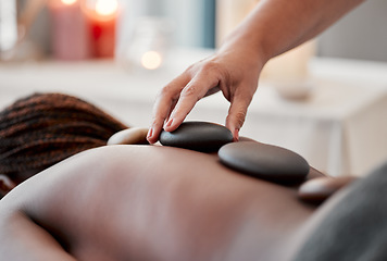 Image showing Hot stone massage, spa and hand of masseuse, holistic care and wellness with black woman and treatment. Health, peace of mind and self care with zen, stress relief for people and back skin detox