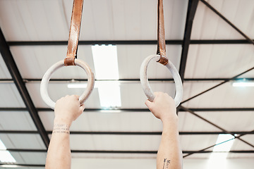 Image showing Hands, rings and gymnastics in fitness for workout, strength training or practice at gym. Hand of athlete, gymnast or acrobat holding or hanging on ring circles for strong intense pull up exercise
