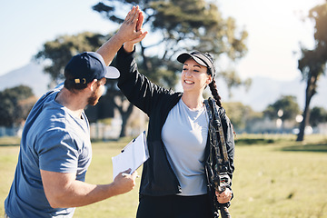 Image showing Woman, archery and personal trainer high five in sports for partnership, success or celebration on the grass field. Happy sporty female smile and touching hand of male coach for archer sport training