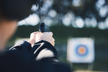 Image showing Firearm, target and person training outdoor at shooting range for game exercise or sports challenge closeup. Man hands with gun, circle and aim for practice, police academy or field practice mission