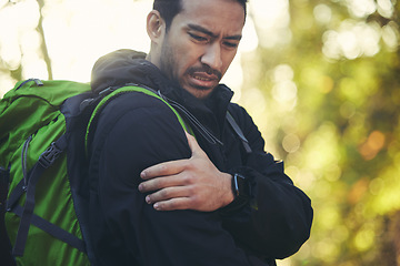 Image showing Man, shoulder pain and hiking in forest, nature or woods with muscle crisis, anatomy problem or fitness accident. Medical, arm and injury emergency for athlete, backpacking hiker or healthcare stress