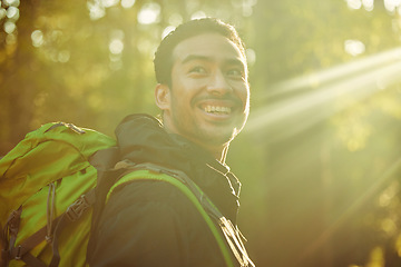 Image showing Man, backpacker or hiker in sunshine forest, trekking woods or nature trees in adventure, morning exercise or Japanese fitness. Smile, happy or hiking in sunrise environment, lens flare or wellness