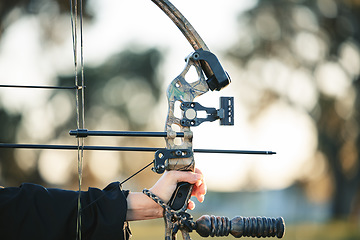 Image showing Archery bow closeup and woman hands at shooting range for competition, game or learning in field or outdoor sports. Person with arrow for gaming, adventure and hunting with aim and target practice