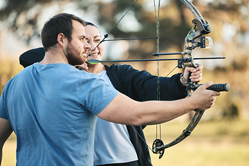 Image showing Archery, bow and shooting range sports training with a woman and man outdoor for target practice. Archer and athlete person with focus on field for competition or game to aim arrow for action