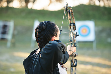 Image showing Archery, shooting range and target for sports training with a woman outdoor for bow practice. Archer athlete person with focus on field for competition or game to aim arrow for action and bullseye