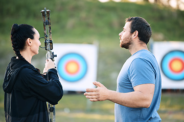 Image showing Sports, archery coach or bow and arrow learning for archer competition, athlete challenge or girl training practice. Teacher, teaching talk or man coaching woman on precision, aim and target shooting