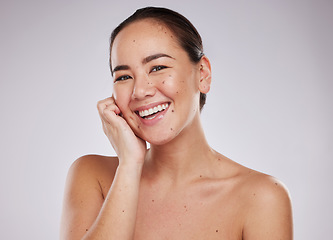 Image showing Asian woman, beauty and face portrait with smile in studio for skincare, dermatology and cosmetics. Happy aesthetic model person with makeup, mole and facial self care for wellness on grey background