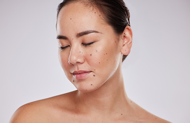 Image showing Skincare, face and beauty of a woman in studio for cosmetic, dermatology and makeup shine. Aesthetic asian model person with wellness glow, mole on skin and luxury facial self care on grey background