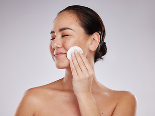 Image showing Face, makeup cotton and woman with eyes closed in studio isolated on a gray background. Skincare hygiene, beauty aesthetics and happy female model with facial pad or product for cleaning cosmetics.