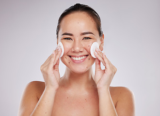 Image showing Face portrait, skincare cotton and Asian woman in studio isolated on a gray background. Makeup hygiene, beauty dermatology and happy female model with facial pad or product for cleaning cosmetics.