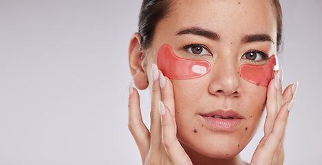 Image showing Skincare, face portrait and woman with eye patches in studio isolated on a gray background mock up. Dermatology, cosmetics and female model with facial pads or products for beauty or skin treatment.