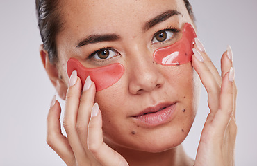 Image showing Skincare, face and woman with eye patches in studio isolated on a gray background. Dermatology, cosmetics and portrait of young female model with facial pads or products for beauty or skin treatment.
