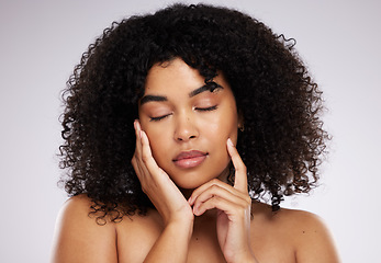 Image showing Dermatology, cosmetics and black woman with eyes closed, hand on face and afro, advertising luxury makeup. Skincare, beauty and facial skin care product promo on model isolated on studio background.