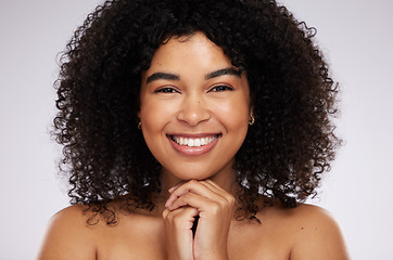 Image showing Portrait, face and afro with a model black woman in studio on a gray background for natural hair treatment. Beauty, skincare and haircare with an attractive young female posing to promote cosmetics