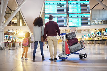 Image showing Family, holding hands and travel waiting at airport checking flight times for departure, trip or vacation together. Mom, father and child touching hand ready for traveling, immigration or holiday