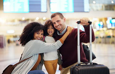 Image showing Happy, interracial and portrait of a family at the airport for travel, holiday and departure. Hug, smile and parents with a child, luggage and hugging affection on a vacation trip leaving together