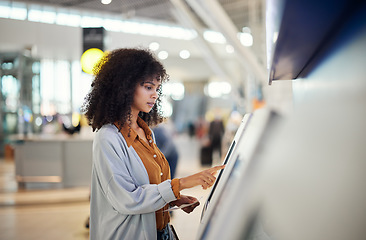 Image showing Black woman, airport and self service station for ticket, registration or online boarding pass. African American female traveler by terminal machine for travel application, document or booking flight