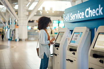 Image showing Black woman, airport and self service kiosk for check in, ticket registration or online boarding pass. African female traveler by terminal machine for travel application, document or booking flight