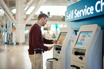 Image showing Man, airport and self service kiosk for check in, ticket registration or online boarding pass. Male traveler by terminal machine for travel application, document or booking flight with luggage