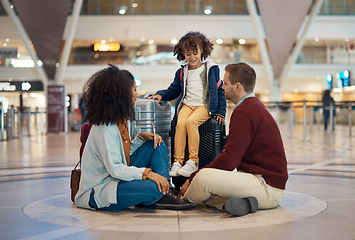 Image showing Family at airport, travel and waiting with luggage, mother and father with child, relax with flight delay and adventure. Terminal, journey and holiday with black woman, man and kid with suitcase