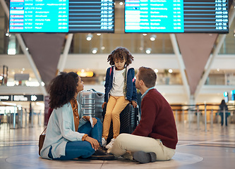 Image showing Family at airport, travel and wait with luggage, mother and father comfort sad child with flight delay and adventure. Terminal, journey and holiday with black woman, man with kid and interracial