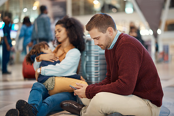 Image showing Phone, tired and interracial family waiting at the airport for a delayed flight. Contact, late and man on a mobile app with a black woman and child sleeping during problems with travel on a trip