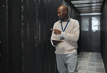 Image showing Tablet, network management and IT black man for software update, working on code in dark server room. Computer, cybersecurity and male programmer with tech for problem solving or troubleshooting