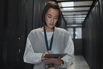 Image showing Tablet, server room and networking with a programmer asian woman at work on a computer mainframe. Software, database and information technology with a female coder working alone on a cyber network