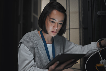 Image showing Tablet, server room and communication with a programmer asian woman at work on a computer mainframe. Software, database and information technology with a female coder working alone on a cyber network