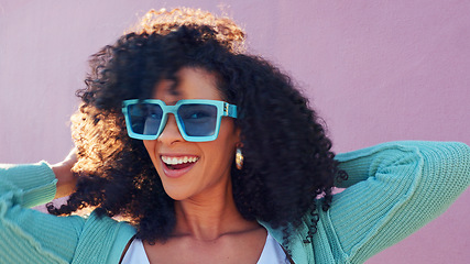 Image showing Fashion, glasses and summer with a woman outside on a pink wall background with a smile and playful attitude. Happy, style and freedom with an attractive young female posing outdoor with sunglasses