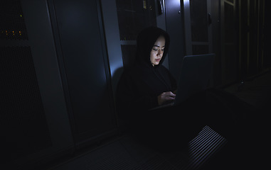 Image showing Hacking, laptop and hacker woman in dark server room for coding software, data center crime or cyberpunk intel. Network criminal, person or user in cybersecurity, information technology or ransomware