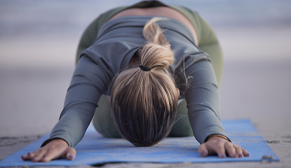 Image showing Woman, yoga and stretching on beach for spiritual wellness, zen or workout in nature. Female yogi in warm up stretch, shishosana pose or pilates for healthy exercise or fitness by the ocean coast