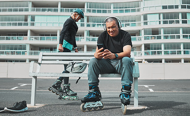 Image showing Roller skate, music and senior couple with phone in city for sports, adventure and fitness hobby outdoors. Retirement, holiday and elderly man and woman ready for skating, relaxing and journey