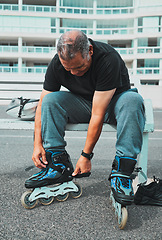 Image showing Roller skate, tie shoes and senior man in city for sports, adventure and fitness hobby outdoors. Exercise, weekend and elderly man with shoelaces ready for skating, urban travel activity and journey