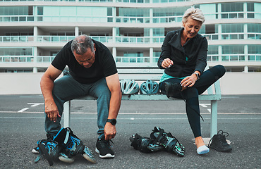 Image showing Roller skate, shoes and senior couple in city tie shoelace for sports, adventure and fitness hobby outdoors. Exercise, holiday and elderly man and woman with pain from skating, travel and journey