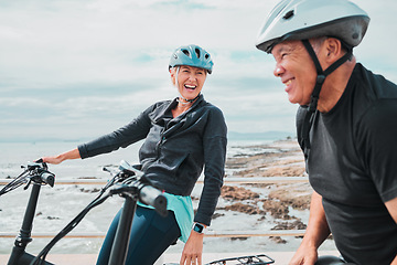 Image showing Laughing couple, helmet or electrical bike by sea in transportation, clean energy or sustainability travel bonding. Technology, electric or eco friendly bicycle for funny woman or mature cycling man