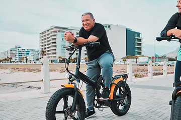 Image showing Mature couple, electrical or bike by sea or ocean beach in bonding transport, clean energy or sustainability street travel. Ebike, electricity or eco friendly bicycle for happy man or cycling woman