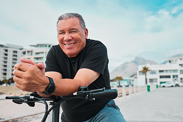 Image showing Portrait, bike and cycling with a senior man on the promenade, riding eco friendly transport for travel. Face, smile and health with a happy mature male cyclist sitting on his bicycle outdoor