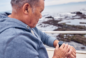 Image showing Smart watch, man and sports exercise at beach promenade of fitness, training or runner wellness. Stopwatch, senior person and workout time of heart rate, monitor healthy progress or data app by ocean