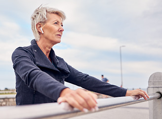 Image showing Serious senior woman, fitness and thinking outdoor for health, exercise and sky mockup. Face of female, music and mindset for sports workout, cardio marathon and listening to radio for running energy