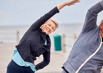 Image showing Stretching, exercise and senior couple in city for pilates, healthy body and wellness in retirement. Sports, fitness and elderly man and woman ready for warm up, cardio workout and training by ocean