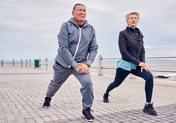 Image showing Stretching legs, fitness and senior couple by ocean for exercise, healthy body and wellness in retirement. Sports, pilates and elderly man and woman ready for warm up, cardio workout and training