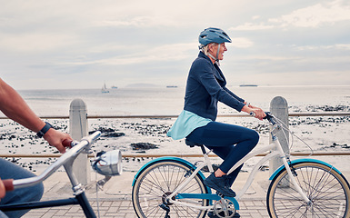 Image showing Old woman on bike at beach, fitness and cycling outdoor, vitality and health, retirement activity by ocean. Cyclist, bicycle and sustainable transport, eco friendly and carbon footprint with hobby