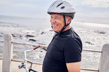 Image showing Happy, senior and man by the beach for cycling, training and eco friendly travel in Portugal. Fitness, smile and an elderly person enjoying retirement with a bike ride by the ocean for exercise